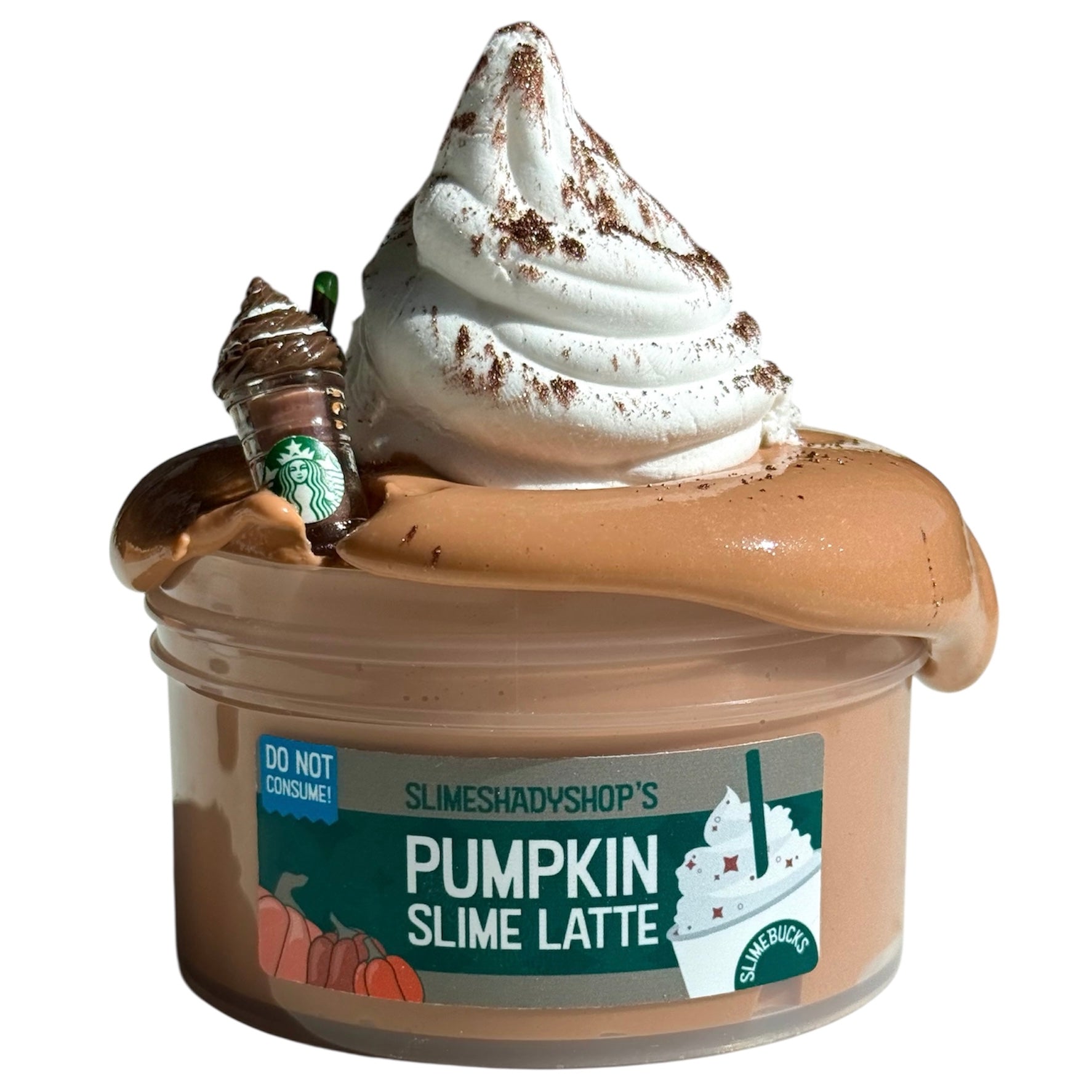 The Pumpkin Spice Latte DIY Clay Slime (7 oz) features a whipped cream clay swirl, a coffee cup charm, pumpkin graphics on the lid, and is scented like a Pumpkin Spice Latte. The lid warns: Do Not Consume!.