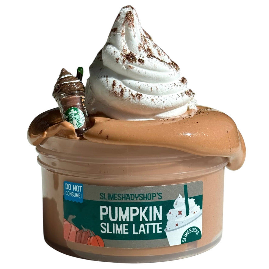 The Pumpkin Spice Latte DIY Clay Slime (7 oz) features a whipped cream clay swirl, a coffee cup charm, pumpkin graphics on the lid, and is scented like a Pumpkin Spice Latte. The lid warns: Do Not Consume!.