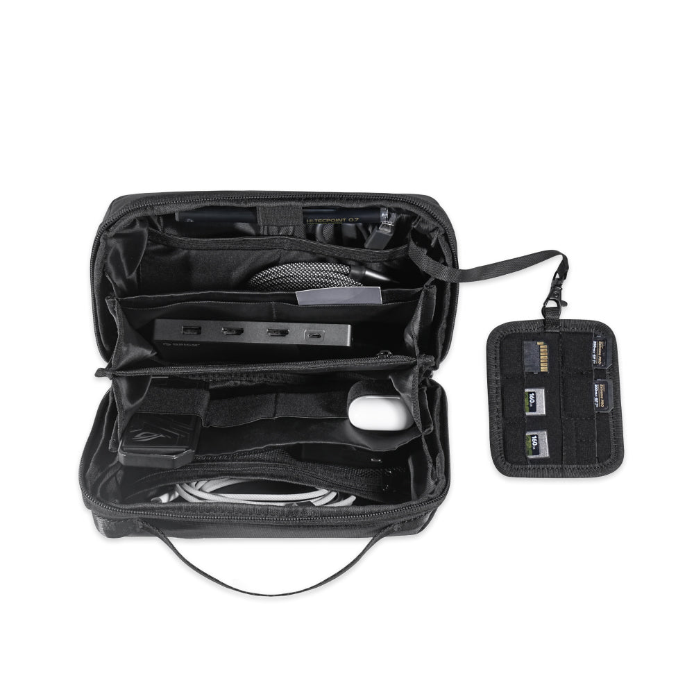 The Tech Pouch in sleek black opens to organize your essentials—cables, a mouse, hub, and four SD cards in a detachable holder—making it the perfect travel accessory for electronic accessories.