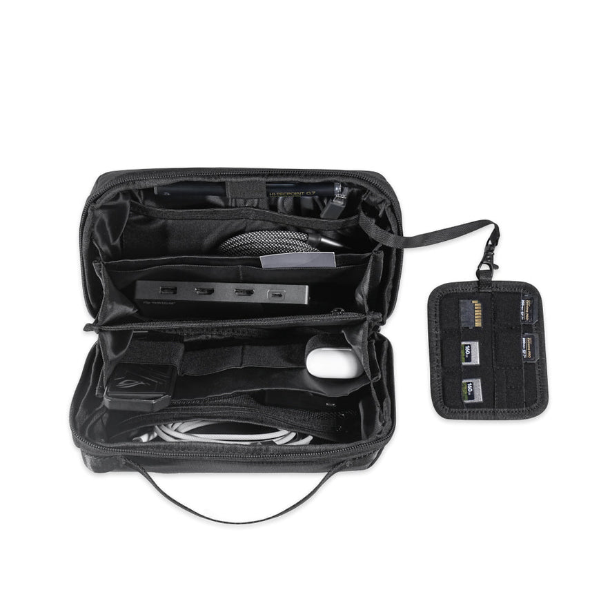 The Tech Pouch in sleek black opens to organize your essentials—cables, a mouse, hub, and four SD cards in a detachable holder—making it the perfect travel accessory for electronic accessories.