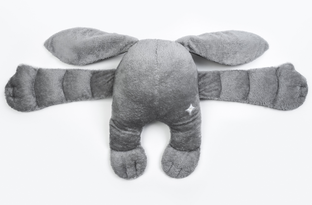 Gamma the Moon Pal – 5 lb Weighted Plush is a gray, abstract, weighted creature with long ears, long arms, and two stubby legs, serving as a calming hug pillow.