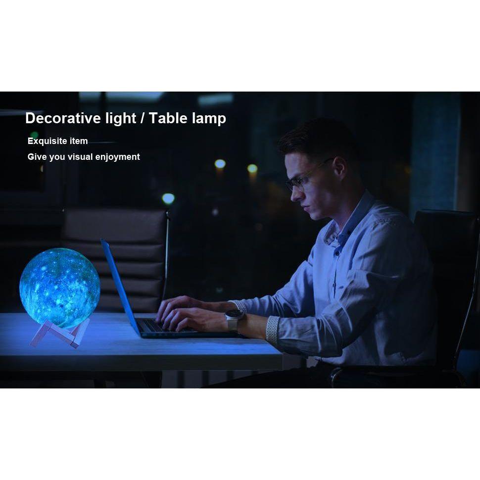 In dim lighting, someone works on a laptop at a desk. To the left, a glowing Celestial 3D Moon Lamp illuminates the space. Text reads Enchanting Starry Decor Gift for Kids and Adults, offering exquisite visual enjoyment as a decorative light or table lamp.