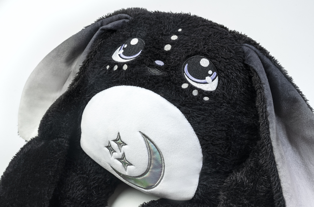Midnight Moon Pal – Collector’s 5 lb Weighted Plush is a black weighted plush with long floppy ears, embroidered purple-tinted eyes, and a white belly patch featuring a crescent moon and stars.