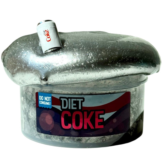 A Diet Coke Scent Lava Rock Slime 7 Oz with a Diet Coke charm, featuring premium silver-coated texture, overflows from its container like metallic fizz, with the can perched atop the shimmering, mushroom-shaped slime.