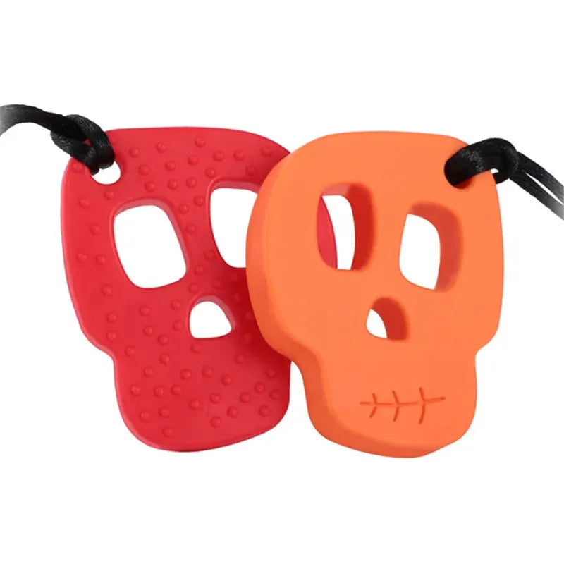 The Silicone Skull Teething Necklace for Babies features two skull-shaped pendants on black cords. The red one has textured dots, and the orange one displays a stitched mouth pattern, making them both stylish accessories and functional chew necklaces for teething relief.