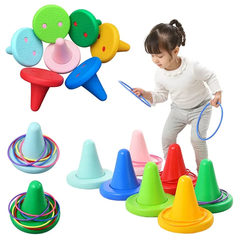 A young child joyfully engages with the Kids Balance Training Unicorner Chair and its colorful throwing rings, a fun sensory game. The set features vibrant cones in green, blue, pink, and yellow hues with hoops for balance training and coordination development.