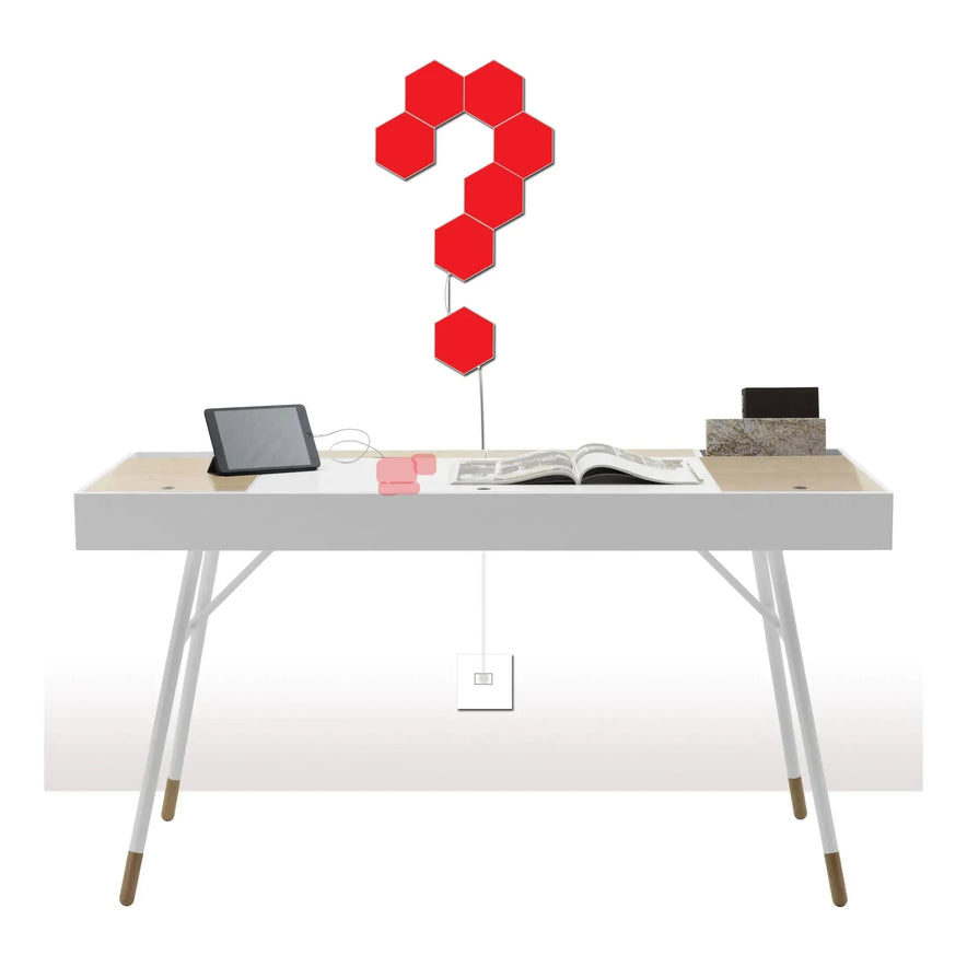 A white desk with an open magazine, tablet, and stacked books. Above, Hexagonal LED Modular Night Light Panels for Sensory Rooms – Calming Splicing Geometry Lamps for Autism form a question mark; color-changing via remote control.