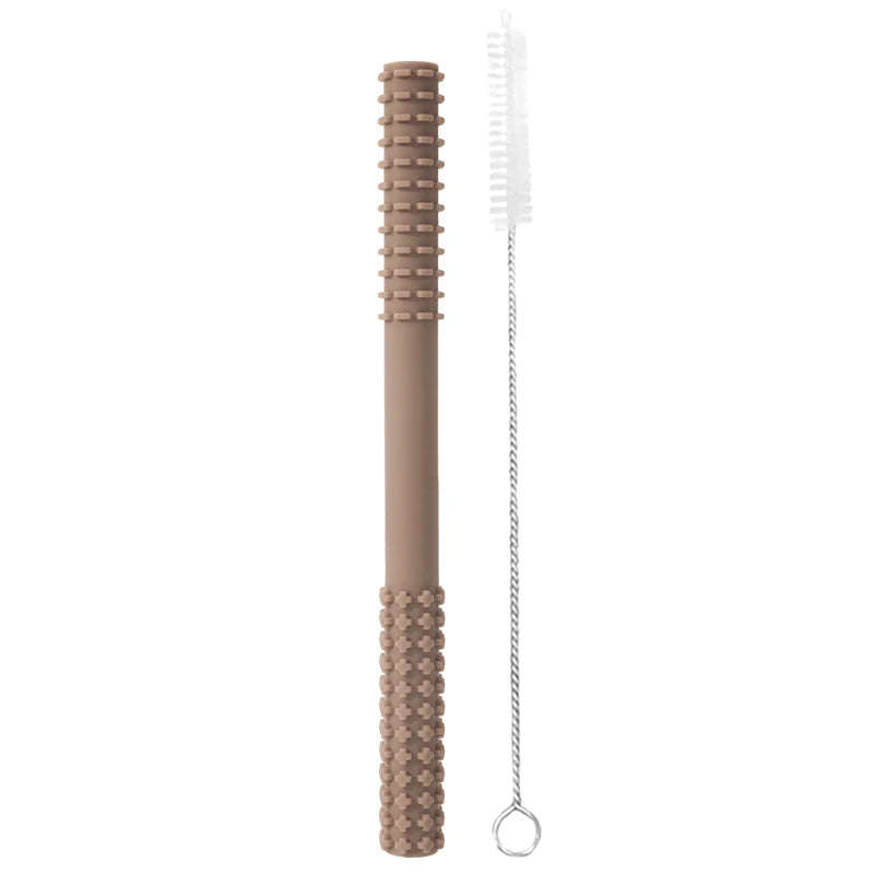 A textured 002-caly silicone teething toy for infants with grip pattern and ridged section promotes healthy development. Includes a narrow bristle cleaning brush with twisted metal handle. Both items are vertically set against a plain white background.