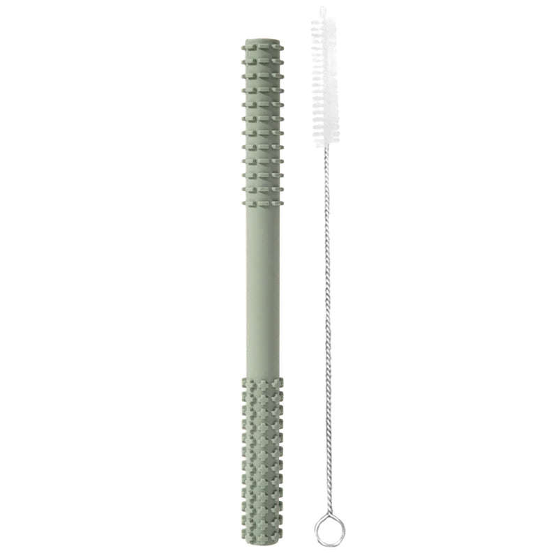 A 007-sage, cylindrical-textured Essential Tiny Teething Toy for infants stands vertically with a cleaning brush against a white background, focusing on protecting baby health.