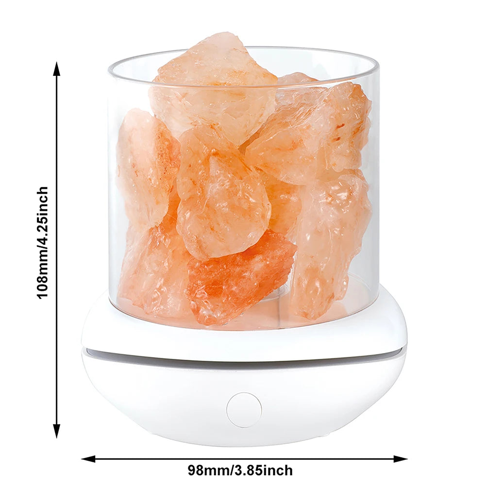 The Crystal Salt Lamp with USB Aroma Purifier is a 108mm tall, 98mm wide cylindrical lamp filled with orange-pink Himalayan salt rocks, sitting on a white base and doubling as a soothing LED multicolor night light to create a serene ambiance in any space.