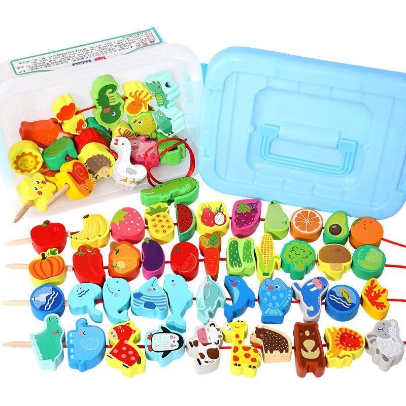 A vibrant assortment of wooden animal and fruit beads, made from safe materials, lies in front of an open blue plastic container. The set includes elephants, apples, and watermelon, providing educational fun with shapes like frogs and chickens from the Wooden Beaded Toys collection.