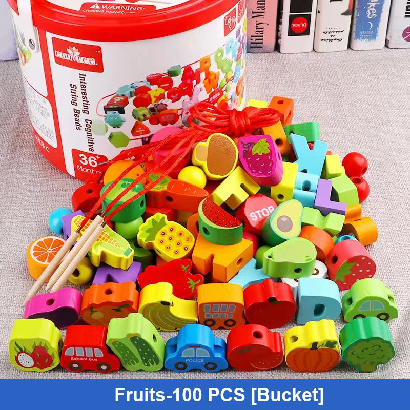 A colorful assortment of fruit and vehicle-themed wooden beads is displayed by a bucket labeled 100PCS Bucket C. These educational toys include strings and sticks for threading and are made from safe materials. Books can be seen in the background.