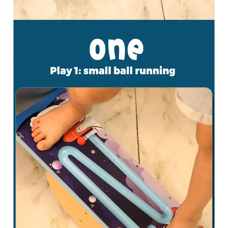 A child can engage in small ball running on the Kids Wooden Balance Board, featuring a space-themed design. This activity guides the ball along a zigzag path while promoting sensory training and physical fitness in an interactive play setting.