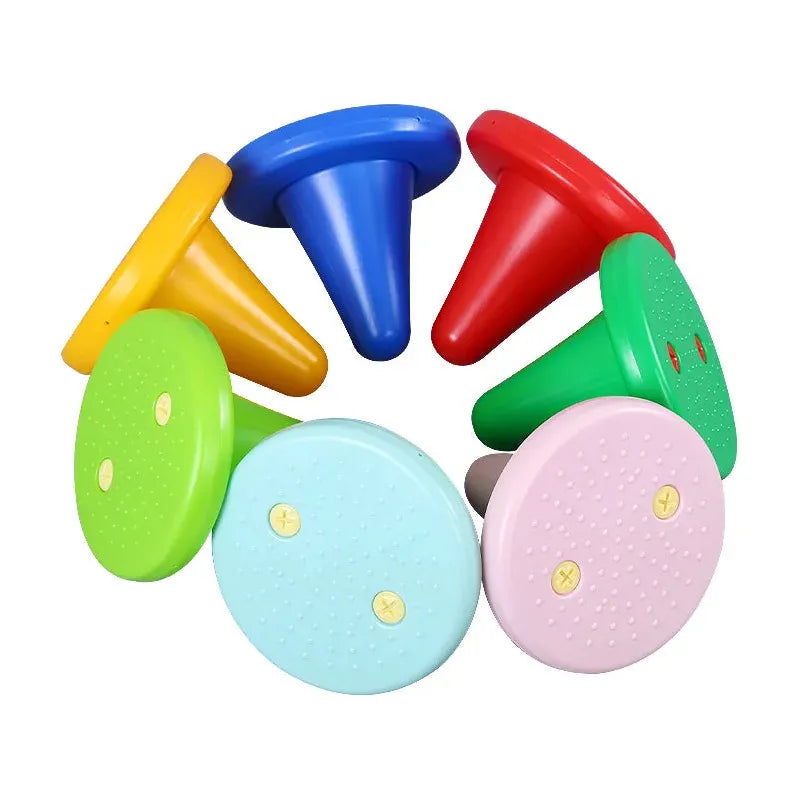 Vibrantly hued, cone-shaped legs on the Kids Balance Training Unicorner Chair with Throwing Ring resemble playful design with flat tops and pointed bases in yellow, blue, red, green, light blue, and pink. Perfect for sensory games enhancing perception and coordination.