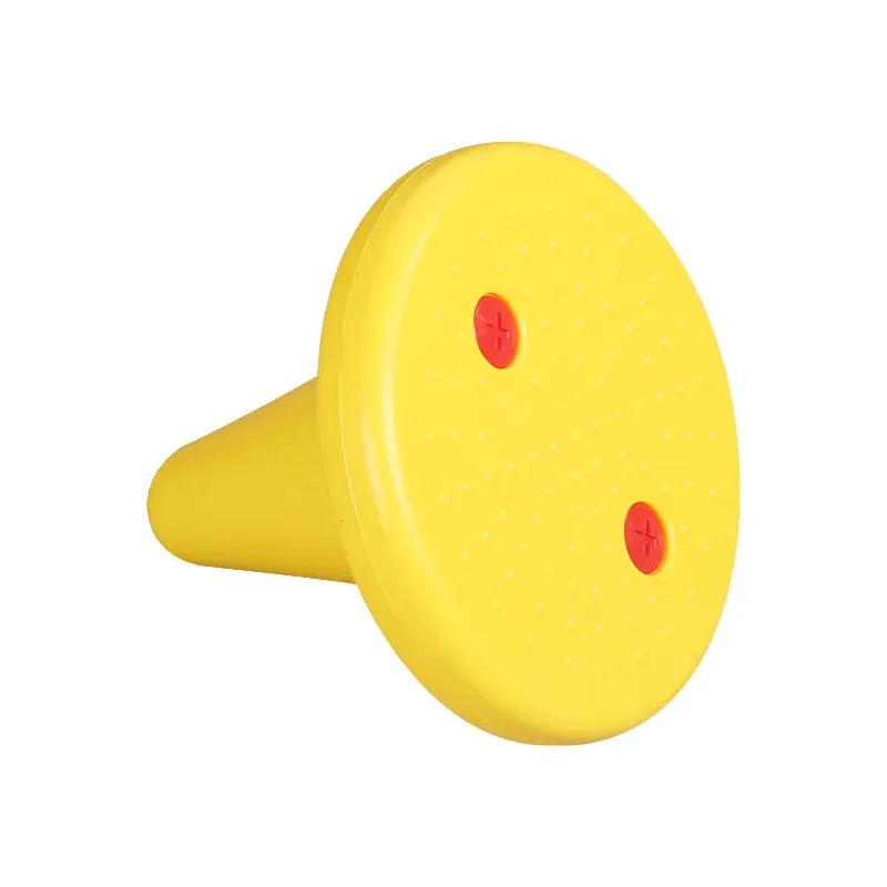 A yellow cylindrical object, similar to the Kids Balance Training Unicorner Chair with Throwing Ring, has a wide circular top with two red plus symbols, a surface with small bumps, and a base that tapers gracefully.
