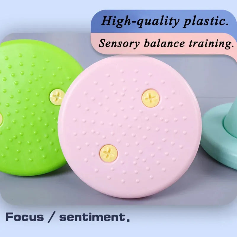 Image of circular Kids Balance Training Unicorner Chair in pink and green with textured surfaces. The text High-quality plastic. Fun sensory game for childrens perception and coordination training. Focus / sentiment. is displayed.