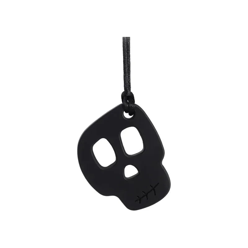 The black Silicone Skull Teething Necklace for Babies, shaped like a stylized skull with cut-out eyes and a stitched pattern on the left jaw, hangs from a string, providing sensory relief. This standout baby teether is perfect for autism and ADHD support against a plain white background.