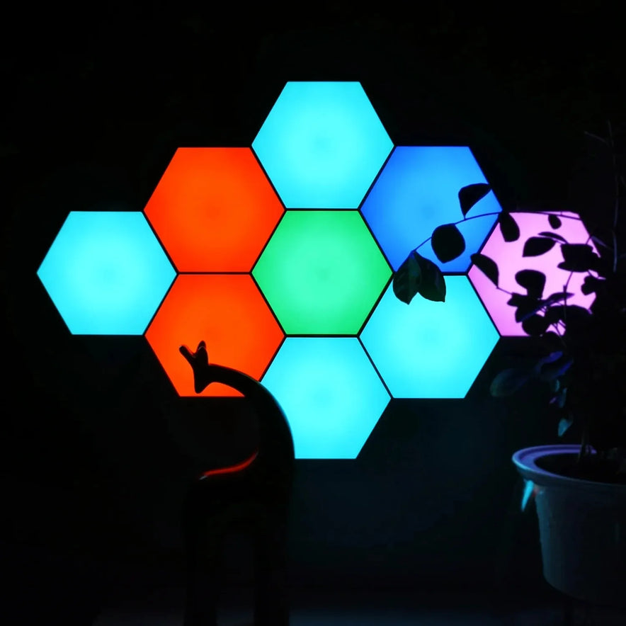 Hexagonal LED Modular Night Light Panels for Sensory Rooms, featuring color-changing blue, red, green, and purple options with remote control, create a calming ambiance above a silhouetted plant and decorative animal figurine.