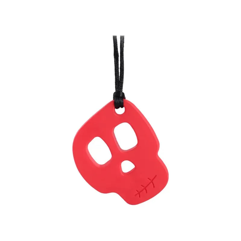 The Silicone Skull Teething Necklace for Babies, a red skull-shaped pendant with eye holes and a stitched cheek pattern, hangs on a black cord against a white background. Its designed as a sensory chewy toy ideal for teething relief, autism, and ADHD support.