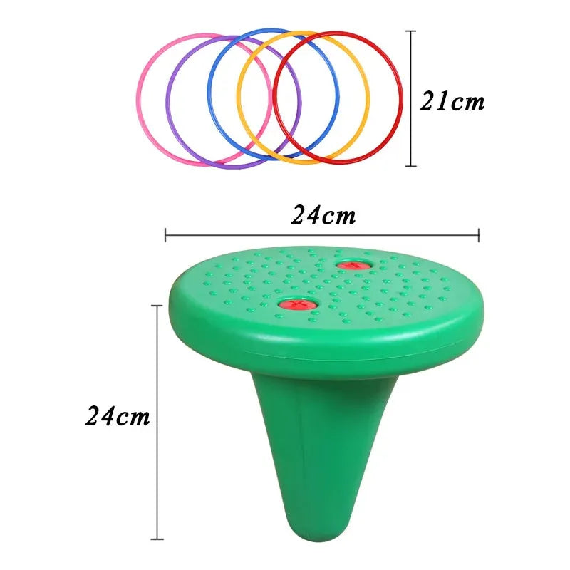 The Kids Balance Training Unicorner Chair is a green plastic cone with a circular top, two red buttons, and perforations, measuring 24cm in diameter and height. It includes six colored rings (pink, blue, orange, yellow, red, purple) each 21cm in diameter for sensory integration and balance training.