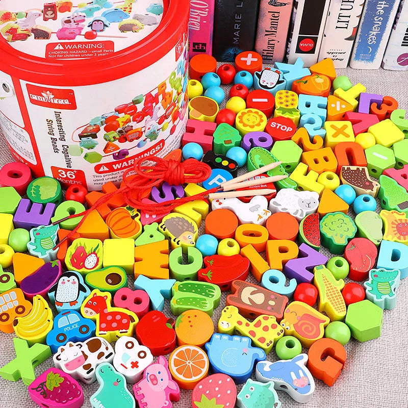 In a container labeled Wooden Beaded Toys, educational beads and shapes spill out, highlighting their value. A red string and two wooden sticks come with these vibrant designs, featuring fruits, letters, numbers, animals on a textured surface and safe materials in front of books.