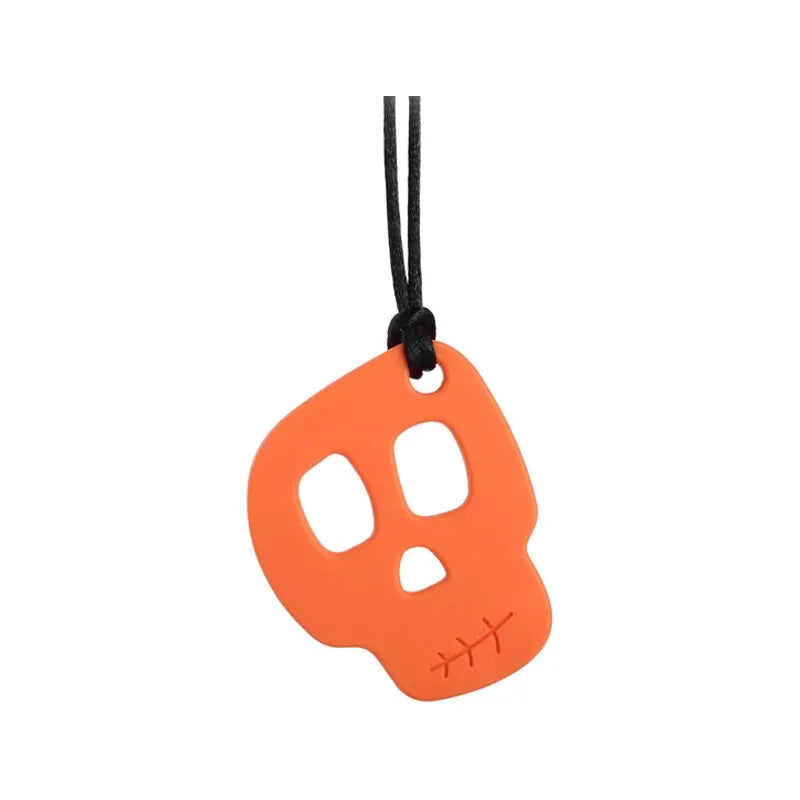 The Silicone Skull Teething Necklace for Babies in orange features a skull-shaped pendant with hollow eye and nose cutouts, hanging from a black cord. It serves as teething relief and a sensory chewy toy for Autism and ADHD, showcasing a stitched chin line against a white background.