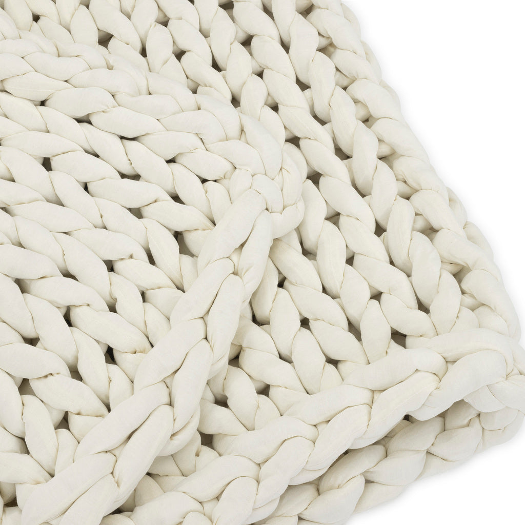Close-up of the Knit Weighted Blanket in off-white, featuring thick braided yarn and a plush, cozy texture against a white background.