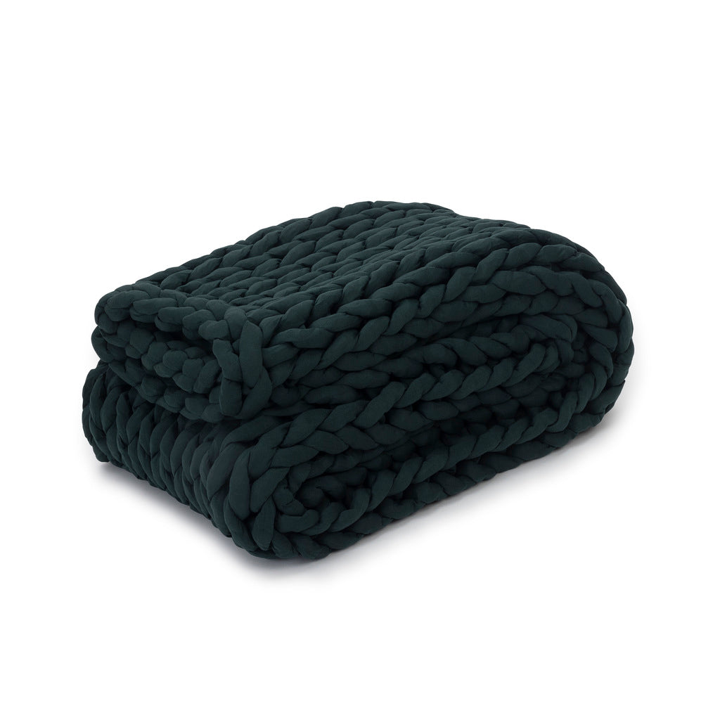 A neatly folded Knit Weighted Blanket in Forest Green with chunky braided yarn is displayed on a white background.