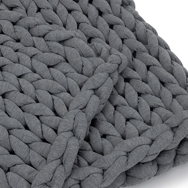 A close-up of the Knit Weighted Blanket in dark gray, highlighting its thick, chunky braided strands and soft, textured look.