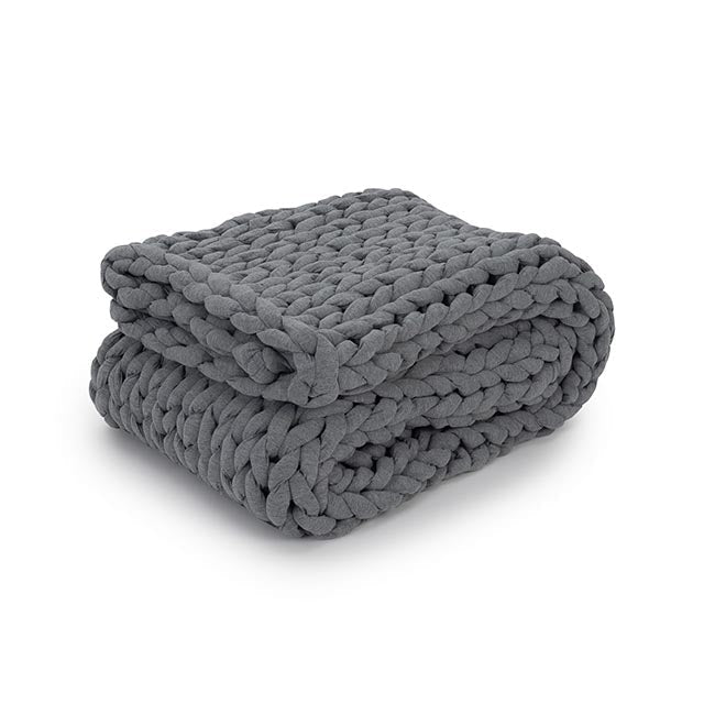 The Knit Weighted Blanket is a chunky, gray braided blanket made with thick yarn, neatly folded and displayed on a plain white background.
