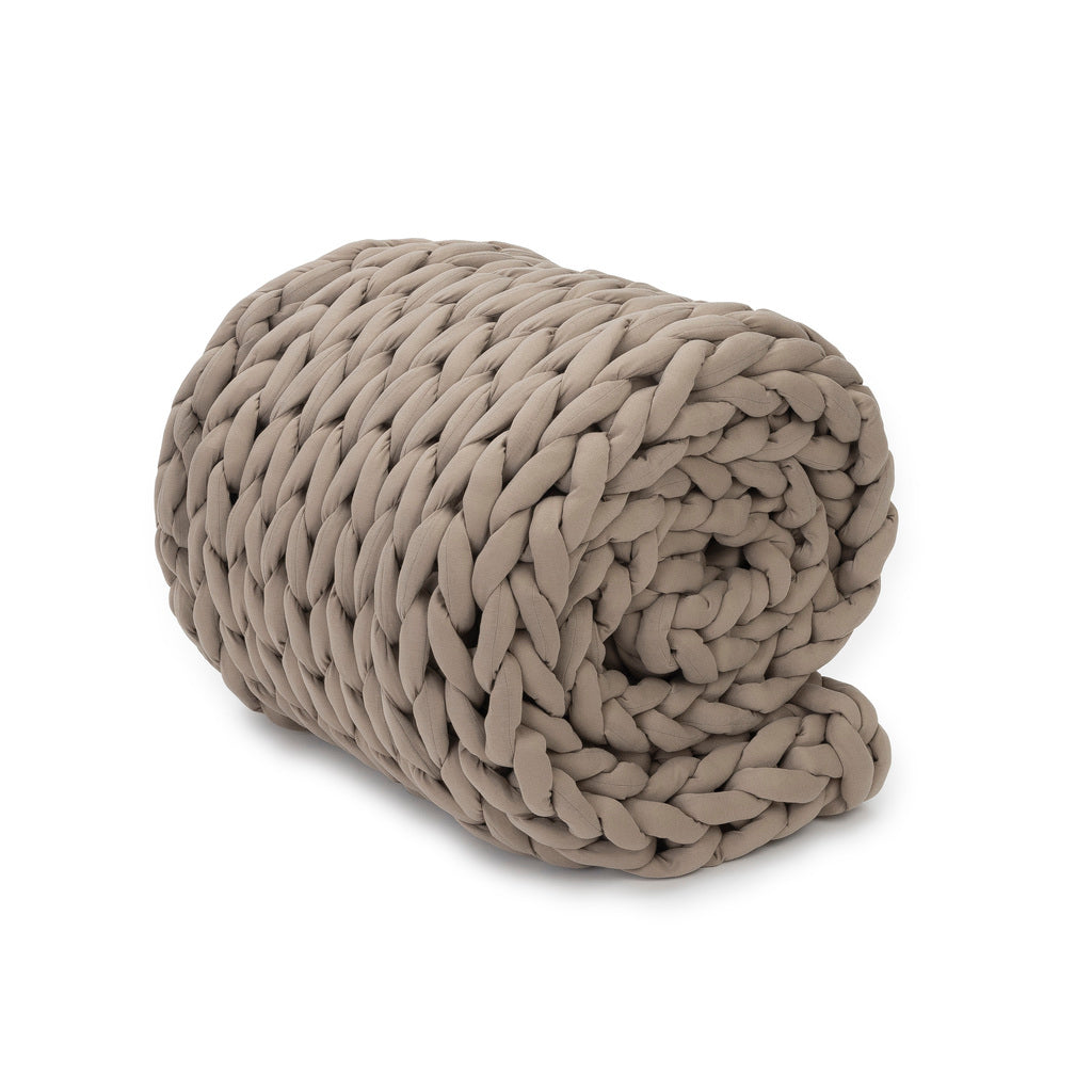 A super soft Knit Weighted Blanket in chunky taupe braid, neatly rolled up on a white background.