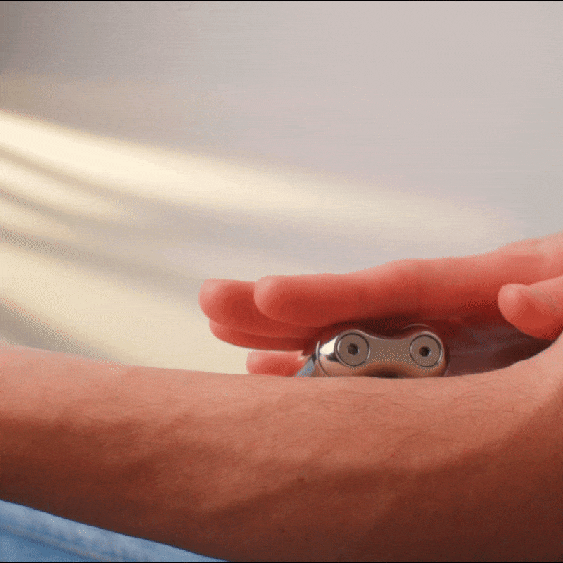 A hand glides the ONO Roller Steel shaver smoothly over a forearm, removing hair in straight strokes. The close-up highlights the shaver and hand set against a soft, neutral background.