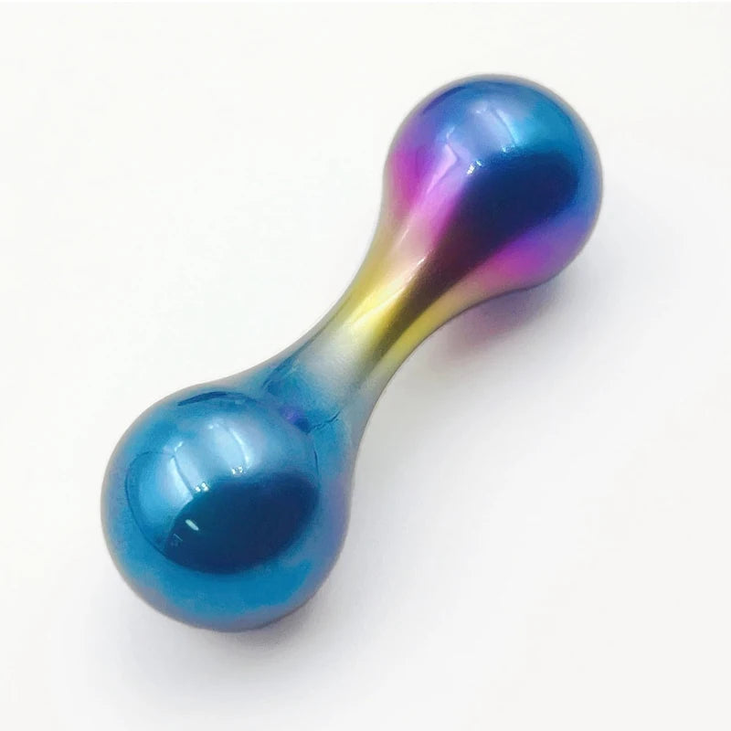 A Stainless Steel Knucklebone Fidget Tool for Anxiety Relief and Focus Enhancement, with a metallic hourglass shape and blue-to-purple gradient, features bulbous ends and a sleek reflective surface on a white background.