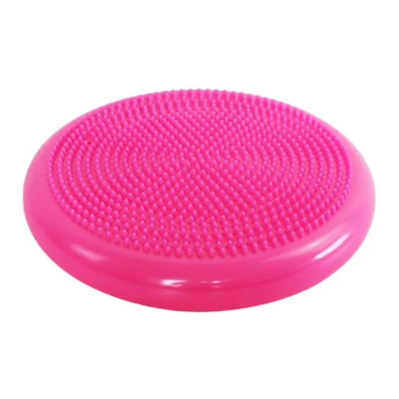 A bright pink, circular balance disc features a textured, spiky surface for sensory integration. Its great for core strength exercises and shares traits with Montessori Sensory Integration Foot Toys for Kids, offering small raised bumps on top for grip.
