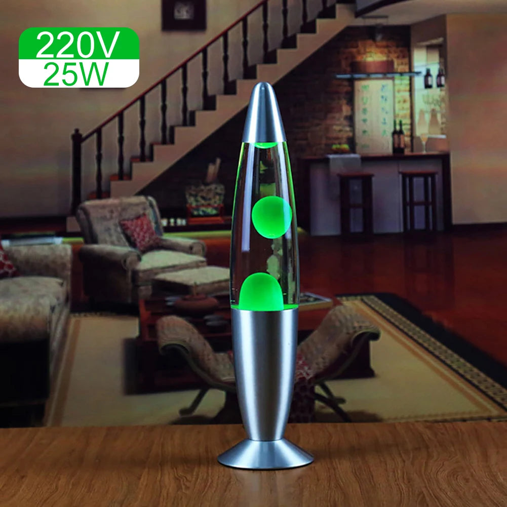 On a wooden table in the living room, the Luminous Volcano Lava Jellyfish LED Night Light, featuring a silver base and cap, casts a relaxing glow. Stairs, a couch, and decorations provide the backdrop. 220V 25W appears in green text at the top left corner.