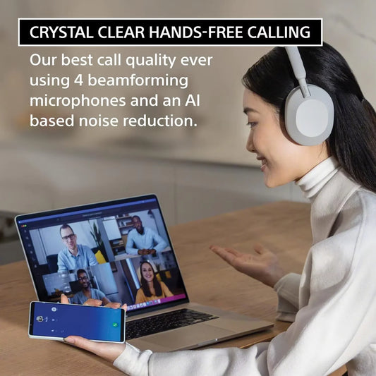 A woman wearing Sony WH-1000XM5 Wireless Noise Canceling Headphones with Integrated Processor V1 and 4 microphones smiles during a video call, showcasing hands-free calling, soft fit leather, and best-in-class noise cancellation.