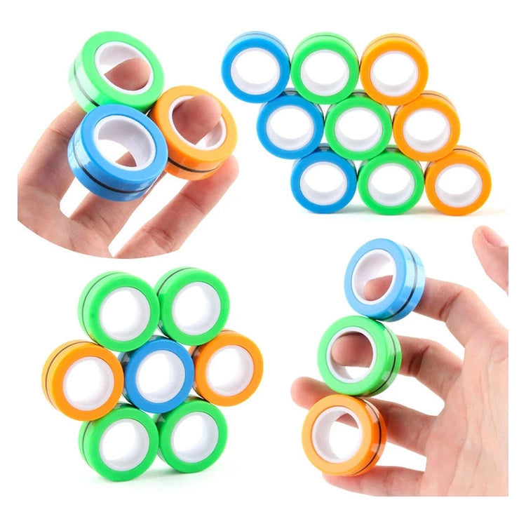 Three hands hold 3PCS Finger Magnetic Rings Fidget Toys in green, blue, and orange with white centers. These stress relief gadgets for anxiety and ADHD are playfully stacked and linked against a clean white background.