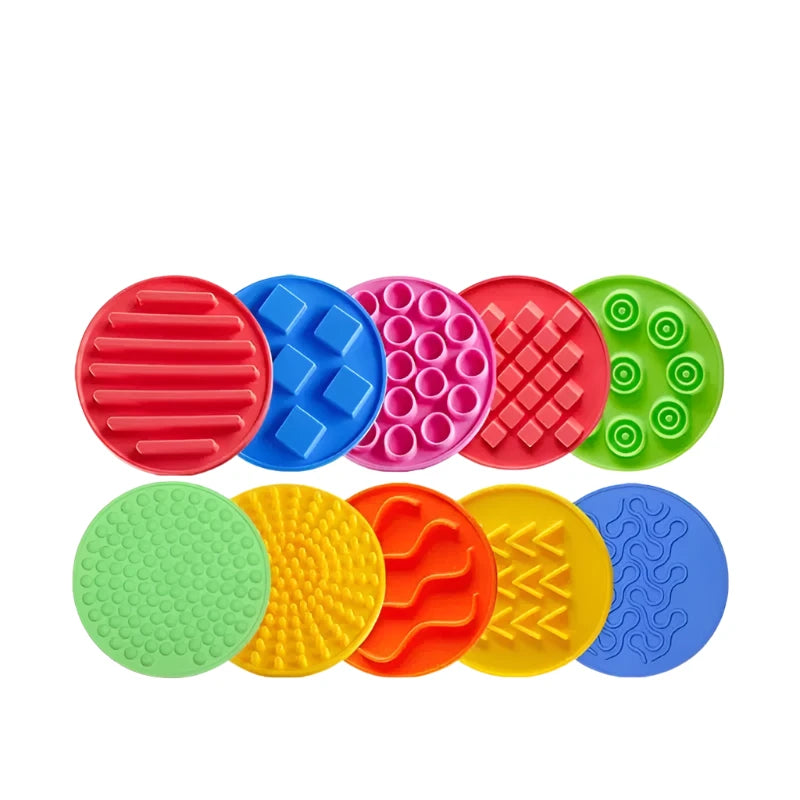 The Montessori Tactile Adventure Mat with Balance Stones includes ten circular, textured silicone pads in vibrant colors like red, blue, pink, green, orange, and yellow. Each pad has unique tactile patterns such as ridges, bumps, or waves to enhance developmental play.