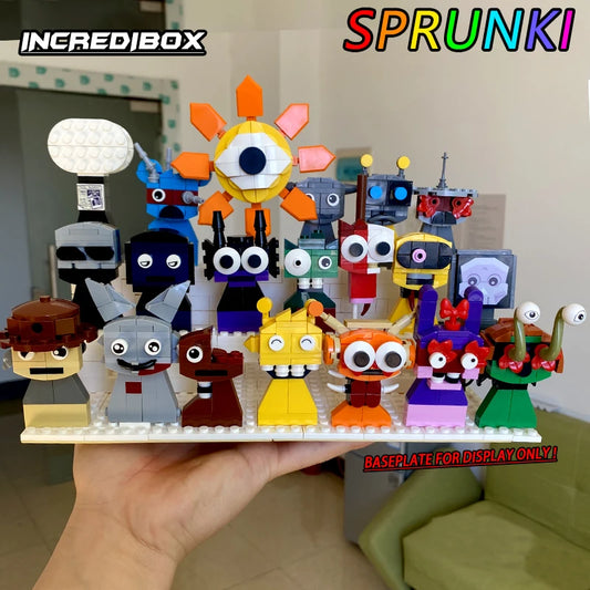 A hand shows colorful LEGO-style creatures from the New Moc Incredibox Sprunki Building Blocks Set. Each has a unique face and expression. Living room in background. Text: INCRDIBOX, SPRUNK!, BASEPLATE FOR DISPLAY ONLY!.