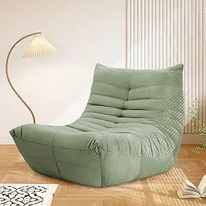 A seagreen Fireside Chair Bean Bag for adults rests on a wooden floor beside a curved floor lamp and white rug, sunlight filtering through vertical blinds in the background.
