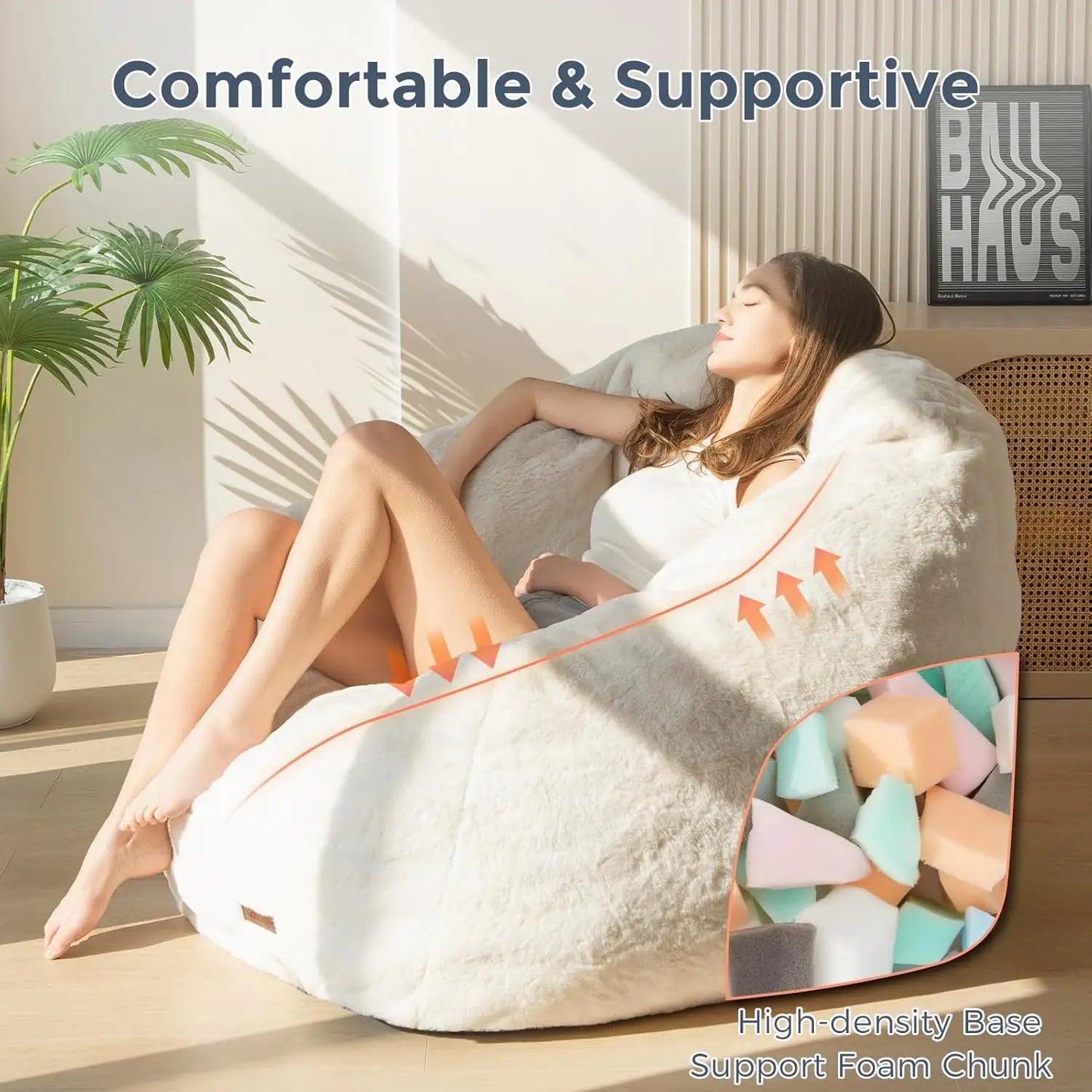 A woman relaxes on the Giant Bean Bag Chair, an oversized faux fur shell-shaped seat for adults and kids, in a bright room with plants. Text reads Comfortable & Supportive. Inset: High-density Base Support Foam Chunk ensures easy assembly.
