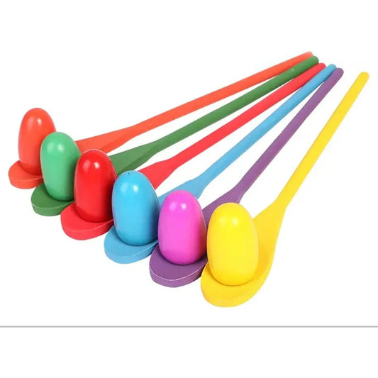The 6-Piece Parent-Child Sensory Balance Game features colorful spoon and egg sets in red, green, cyan, purple, blue, and yellow. These toys line up for a fun outdoor experience focused on developing skills through sensory play.