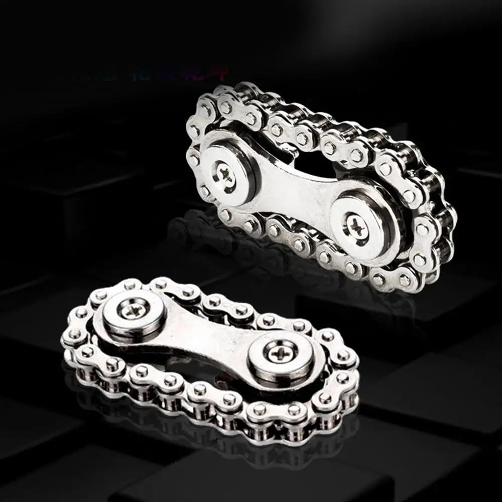 Close-up of two metallic Sprockets Flywheel Fingertip Gyro Fidget Spinners on a dark background. Each resembles a bike chain with two central circular gears and interconnected links, creating a distinctive gear-like design ideal for dropshipping enthusiasts.