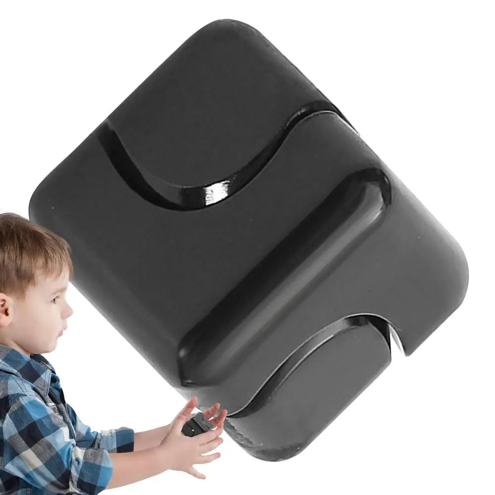A young child in a plaid shirt holds a large, glossy black Infinity Gear Cube Spinner Antistress Toy with curved grooves, isolated on a white background.