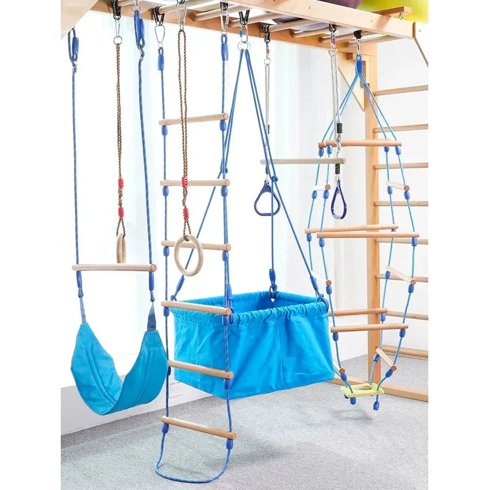 The Indoor Sensory Fitness Ladder for Kids is a playground set with blue swings, ladders, and climbing ropes on a wooden frame that doubles as a sensory integration tool, featuring a fabric swing seat and climbing rings for endless play and exercise.