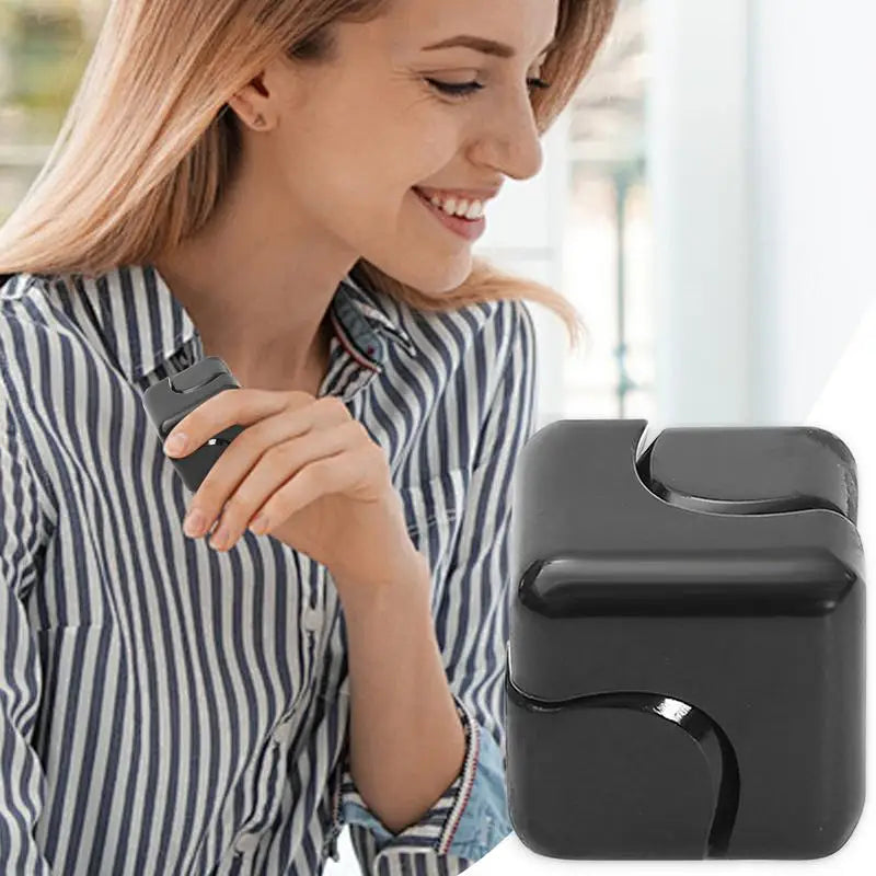 A smiling woman in a striped shirt uses the Infinity Gear Cube Spinner Antistress Toy near her face. A close-up highlights its square shape and curved grooves. This popular fidget block is a hit in Mainland China for stress relief.