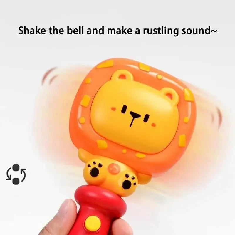 A hand grips a vibrant toy bell with a cartoon bear face, functioning as a Musical Teething Rattle. The red handle has button details. Text reads, Shake the bell and make a rustling sound~. Motion lines depict the Interactive Learning Toy in action.