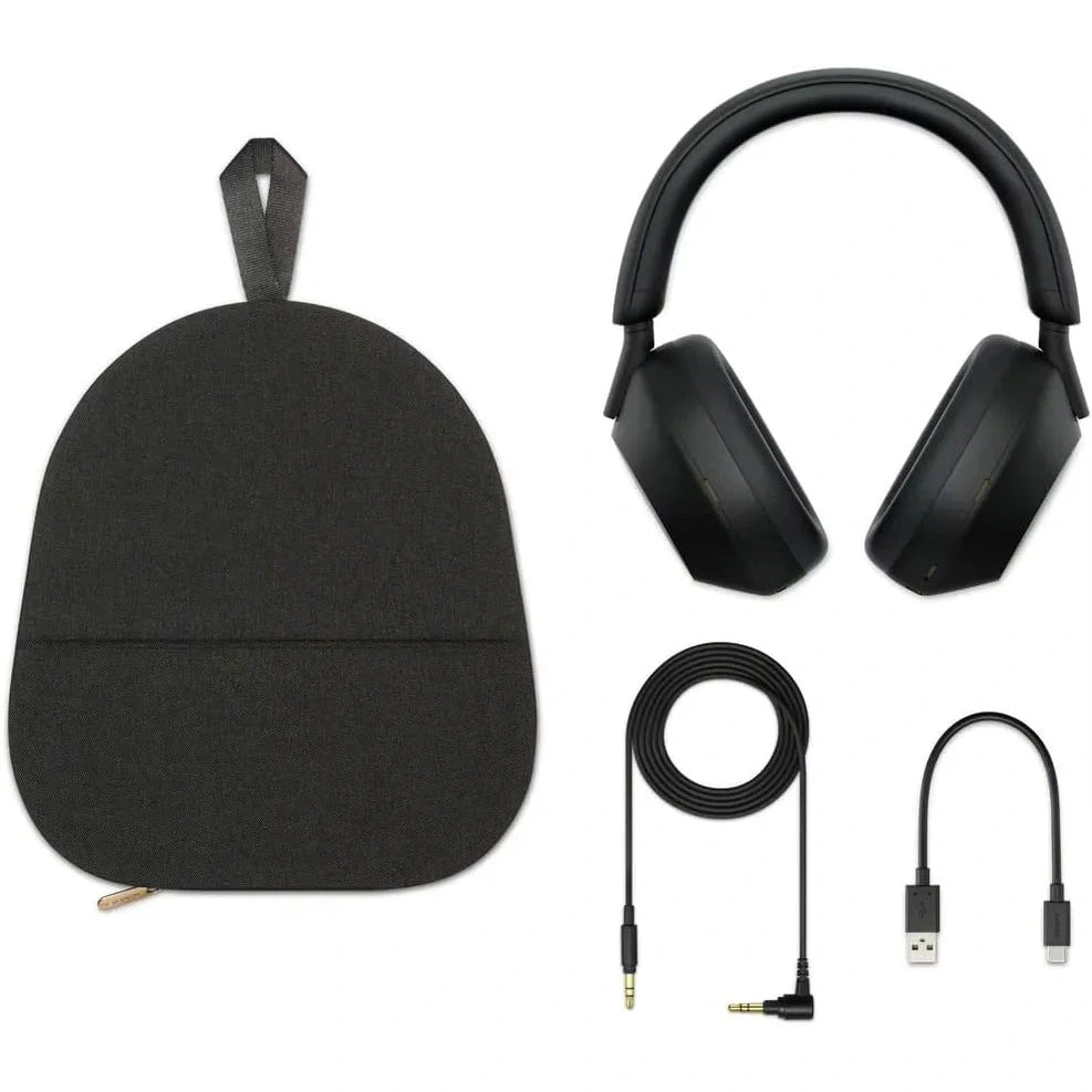 A black Sony WH-1000XM5 Wireless Noise Canceling Headphones set with Soft Fit Leather, 4 microphones, and 30-hour battery is shown on a white background with its carrying pouch, long audio cable, USB charging cable, and USB adapter.