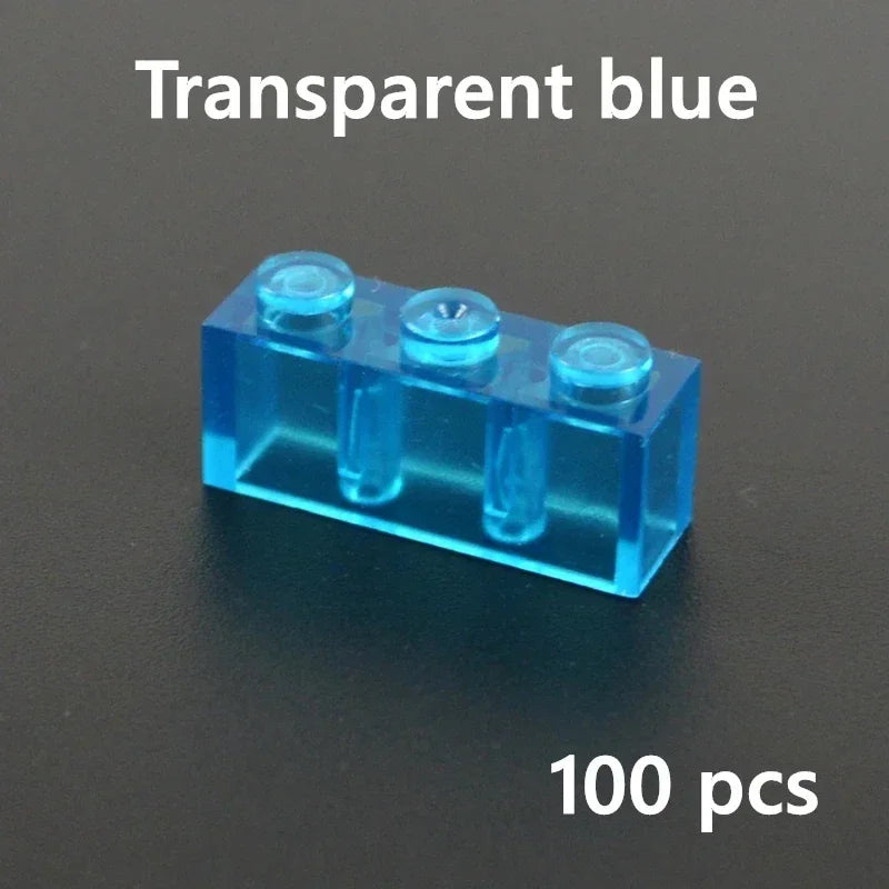 A transparent blue 1x3 brick, compatible with Lego, is shown on a black background. White text above reads blue 1x3 and text below reads 100 pcs—ideal for your MOC building block collection.