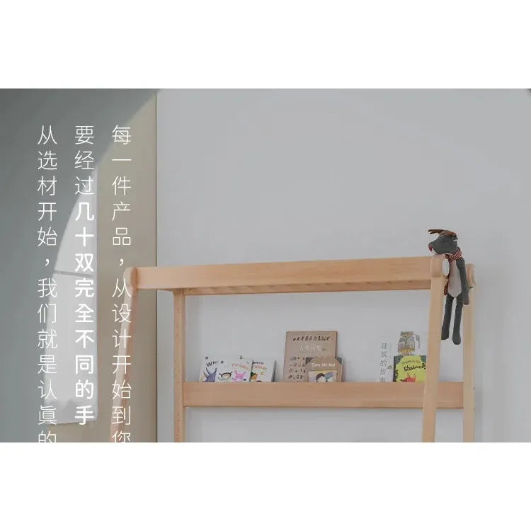 A wooden shelf with childrens books rests against a light wall. A small stuffed animal is on the top right corner. Chinese text appears vertically on the left, next to the Versatile Solid Wood Childrens Bed with a climbing frame and swing nearby.